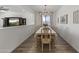 Elegant dining room showcasing a dining table with seating for six and a view into the living room at 22657 N 184Th Ln, Surprise, AZ 85387
