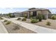 Inviting single-story home showcases a well-manicured front yard and a cozy, neutral color palette at 22657 N 184Th Ln, Surprise, AZ 85387
