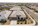 Aerial front view showcases the home's neutral facade, desert landscaping, and attached two car garage at 22657 N 184Th Ln, Surprise, AZ 85387