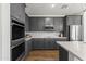 Elegant kitchen with sleek gray cabinetry, stainless steel appliances, and modern tile backsplash at 22657 N 184Th Ln, Surprise, AZ 85387