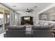 Comfortable living room showcasing stylish furnishings, a large TV, and sliding glass doors to an outdoor patio at 22657 N 184Th Ln, Surprise, AZ 85387
