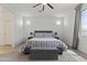 Calm main bedroom with plush carpeting, a king-size bed, neutral decor, and ample natural light from a window at 22657 N 184Th Ln, Surprise, AZ 85387
