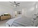 Spacious main bedroom featuring a ceiling fan, a dresser with a TV, and neutral-toned walls at 22657 N 184Th Ln, Surprise, AZ 85387