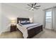 Comfortable bedroom with a dark wood bedframe, stylish bedside tables, and a ceiling fan at 22657 N 184Th Ln, Surprise, AZ 85387