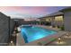 Backyard view of a pool and spa illuminated at dusk, creating a serene outdoor retreat at 22657 N 184Th Ln, Surprise, AZ 85387