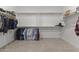 Large walk-in closet with multiple rods for hanging clothes and plenty of storage space at 22657 N 184Th Ln, Surprise, AZ 85387