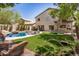 A luxurious backyard features a sparkling pool, spiral staircase, and lounging area at 2746 E Fawn Dr, Phoenix, AZ 85042