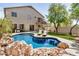 Stunning backyard showcasing a pool, deck, spiral staircase, and meticulously kept landscaping at 2746 E Fawn Dr, Phoenix, AZ 85042