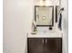 Charming powder room with a framed mirror, white countertop and dark brown wood cabinetry at 2746 E Fawn Dr, Phoenix, AZ 85042