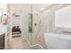 Spa-like bathroom with a modern shower, freestanding tub, and tiled walls at 2746 E Fawn Dr, Phoenix, AZ 85042