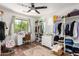 Stylish bedroom with a ceiling fan, a vanity table, and a walk-in closet, offering a chic and functional space at 2746 E Fawn Dr, Phoenix, AZ 85042