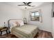 Cozy bedroom with a window view, modern ceiling fan, and neutral decor, creating a calm and inviting atmosphere at 2746 E Fawn Dr, Phoenix, AZ 85042