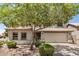 Attractive home featuring a two-car garage, lush landscaping, and mature shade tree at 2746 E Fawn Dr, Phoenix, AZ 85042