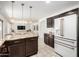 Open kitchen flows to the living room, featuring stainless steel appliances and granite countertops at 2746 E Fawn Dr, Phoenix, AZ 85042