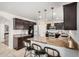 Stylish kitchen featuring granite countertops, a breakfast bar, and dark wood cabinets at 2746 E Fawn Dr, Phoenix, AZ 85042