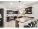 Stylish kitchen with dark cabinets, granite countertops, pendant lighting, and modern appliances at 2746 E Fawn Dr, Phoenix, AZ 85042