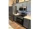 Modern kitchen featuring stainless steel appliances, gray cabinets, and granite countertops at 29954 N Broken Shale Dr, San Tan Valley, AZ 85143