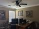Cozy office space with a ceiling fan, a window for natural light, and a workspace with a computer at 29954 N Broken Shale Dr, San Tan Valley, AZ 85143