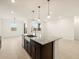 Bright, open kitchen featuring granite counters and a modern kitchen island with a sink at 3550 N Camden Dr, Florence, AZ 85132