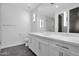 Well-lit bathroom with modern vanity, large mirror, and contrasting tile floor at 3718 E Sells Dr, Phoenix, AZ 85018