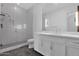 Modern bathroom with a glass-enclosed shower, stylish vanity and grey tiled floors at 3718 E Sells Dr, Phoenix, AZ 85018