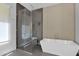 Modern bathroom featuring a glass shower and white soaking tub at 3718 E Sells Dr, Phoenix, AZ 85018