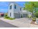 Bright white home with a two-car garage, modern design, and well-kept landscaping at 3718 E Sells Dr, Phoenix, AZ 85018