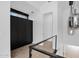 Bright upstairs hallway with a unique chandelier and striking black storage cabinetry at 3718 E Sells Dr, Phoenix, AZ 85018