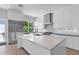 Stylish white kitchen with an island, stainless steel appliances, and light countertops at 3718 E Sells Dr, Phoenix, AZ 85018