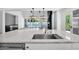 Modern kitchen with marble countertops, stainless steel appliances, and view of outdoor pool area at 3718 E Sells Dr, Phoenix, AZ 85018