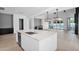 Bright, open-concept kitchen featuring a large island, pendant lighting, and sleek, modern finishes at 3718 E Sells Dr, Phoenix, AZ 85018