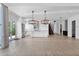Expansive living space with open kitchen, modern lighting, and staircase, creating an inviting ambiance at 3718 E Sells Dr, Phoenix, AZ 85018