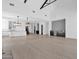 Spacious living room with open kitchen, staircase, and modern lighting creating an inviting ambiance at 3718 E Sells Dr, Phoenix, AZ 85018