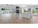 Open-concept living space with hardwood floors, fireplace, and doors to the backyard at 3718 E Sells Dr, Phoenix, AZ 85018
