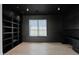 Contemporary office with sleek black built-in shelving and cabinetry and a light wood floor at 3718 E Sells Dr, Phoenix, AZ 85018