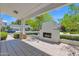 Relaxing outdoor patio with a fireplace, tiled flooring, and lush green surroundings at 3718 E Sells Dr, Phoenix, AZ 85018