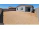 A large, empty backyard ready for landscaping with block wall and covered patio at 3805 N Camden Dr, Florence, AZ 85132