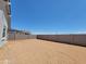 A large, empty backyard ready for landscaping with a tall block wall at 3805 N Camden Dr, Florence, AZ 85132