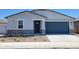 Charming single-story home showcasing a blue garage door and professionally landscaped front yard at 3805 N Camden Dr, Florence, AZ 85132