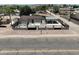 Aerial view of a cozy home featuring a large parking area, carport, and fenced yard at 404 E Centre Ave, Buckeye, AZ 85326