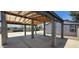 Covered carport area with exposed wood rafters and concrete pillars for protected parking at 404 E Centre Ave, Buckeye, AZ 85326