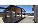Spacious carport featuring wooden rafters, concrete pillars, and durable concrete slab at 404 E Centre Ave, Buckeye, AZ 85326