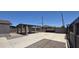 A spacious concrete parking area with a covered carport at 404 E Centre Ave, Buckeye, AZ 85326