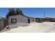 Exterior view of home with block perimeter wall and covered parking at 404 E Centre Ave, Buckeye, AZ 85326