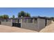 Exterior view showing the house, carport and large concrete area within a gated lot at 404 E Centre Ave, Buckeye, AZ 85326