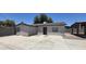 Exterior view showing the home's front door and spacious concrete patio at 404 E Centre Ave, Buckeye, AZ 85326