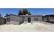 Exterior view showing the home's front door and spacious concrete patio at 404 E Centre Ave, Buckeye, AZ 85326