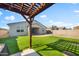Backyard featuring putting green, basketball court, covered patio, and pergola covered hot tub at 4143 E Sidesaddle Rd, San Tan Valley, AZ 85140