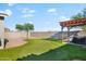 Spacious backyard featuring basketball court, putting green, hot tub under pergola at 4143 E Sidesaddle Rd, San Tan Valley, AZ 85140