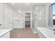 Bright bathroom featuring a soaking tub, glass enclosed shower, and double vanity at 4143 E Sidesaddle Rd, San Tan Valley, AZ 85140